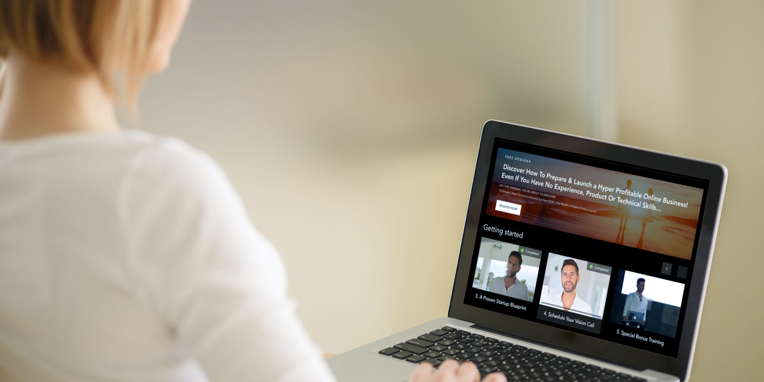 Exploring Video Series on a Laptop A woman sitting and using a laptop displaying a video series interface with multiple thumbnails and text.